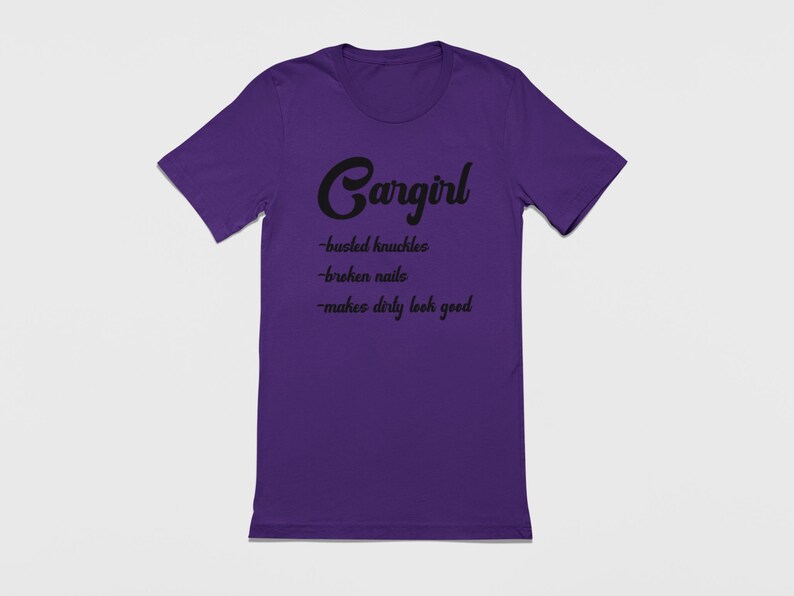 May include: Purple t-shirt with black text that reads "Cargirl -bucked knuckles -broken nails -makes dirty look good"