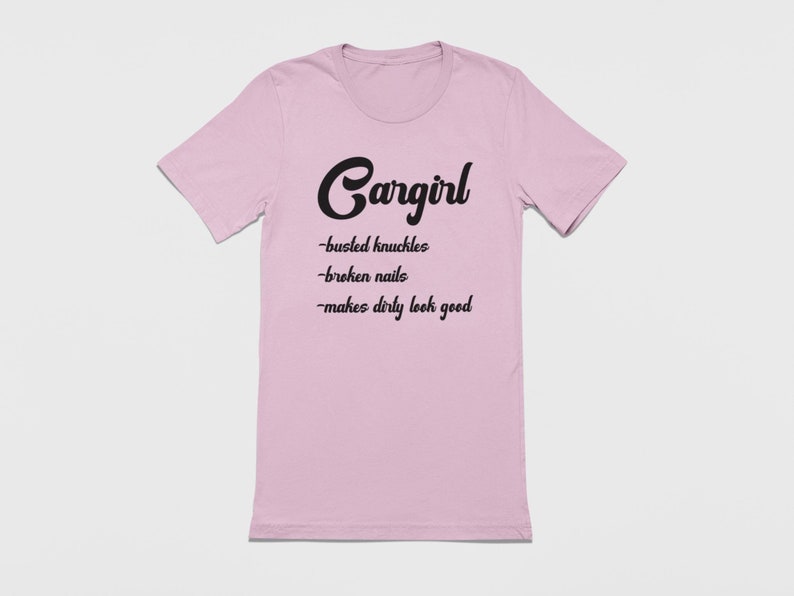 May include: Pink t-shirt with black text that reads "Cargirl - busted knuckles - broken nails - makes dirty look good"