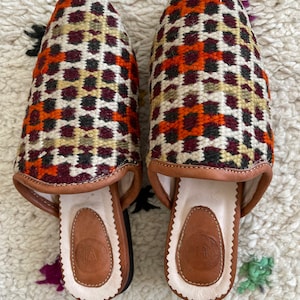 Handmade Moroccan vintage carpet rug slippers with soft lined organic leather and hard leather organic sole with the hand of Fatima