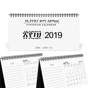 May include: A white desk calendar with black wire binding featuring the text Ethiopian Calendar, 2019, and 2026 | 2027 G.C. The interior pages display monthly grids with Amharic and English text, alongside lined sections for notes on each page.