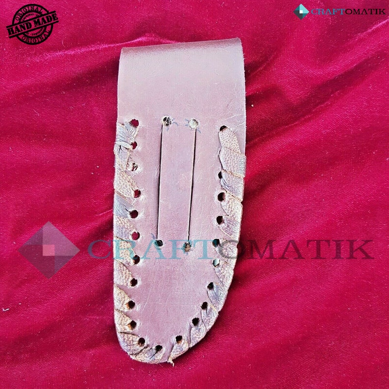 May include: A brown leather sheath with a decorative stitch pattern. The sheath has a flap that closes with a snap. The sheath is designed to hold a knife or other small tool.