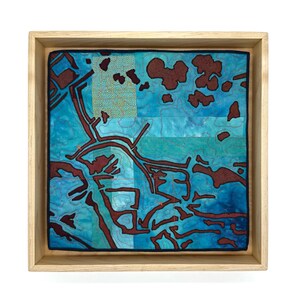 Colcha enmarcada Pass A Loutre de 12” x 12”