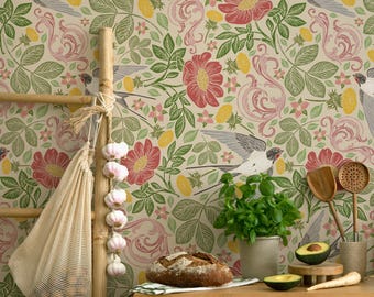 May include: A kitchen scene with a wooden cabinet, a loaf of bread, and fresh produce. A bamboo ladder holds a mesh bag of garlic. The background features floral wallpaper with birds, flowers, and leaves. Wooden spoons and a potted plant are also visible.