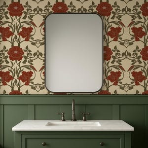 May include: A bathroom vanity with a white marble countertop and a dark green cabinet. A rectangular mirror with rounded corners hangs above the sink. The wallpaper features a floral pattern with red flowers and green leaves on a cream background.