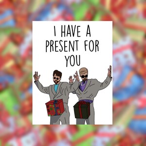 May include: Greeting card with the text "I HAVE A PRESENT FOR YOU." The illustration features two figures in gray suits and sunglasses, each holding a gift box. One box is red and the other is black.