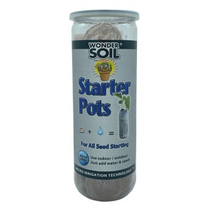 May include: A clear plastic container filled with brown starter pots for planting seeds. The container has a label that reads "Wonder Soil Starter Pots" with a cartoon character and the text "For All Seed Starting. Use indoor/outdoor. Just add water & seeds. Micro Irrigation Technology."