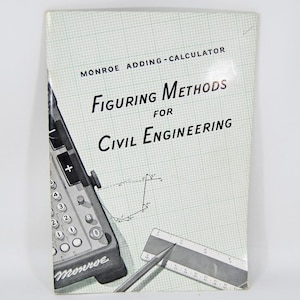 May include: Vintage book titled "Figuring Methods for Civil Engineering" with a Monroe adding calculator illustration. The cover is light green with a grid pattern. A pencil and ruler are also visible. The book is a manual for civil engineers.