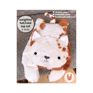 May include: A plush weighted cat toy with white and brown fur, featuring embroidered black eyes and a nose. Text on the image reads: weighted hot/cold lap cat 2-12 lbs, choose colors, washable cover, handmade with love. The cat has a long tail.