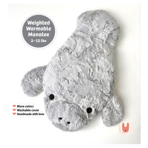 May include: A grey plush manatee toy with a soft, textured surface and two small black circular eyes. Text on the image reads: Weighted Warmable Manatee 2-12 lbs, More colors, Washable cover, Handmade with love. The manatee has two side flippers.