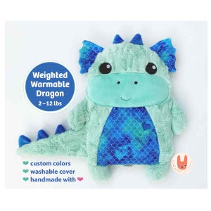May include: A plush dragon toy with mint green fur, blue scale-patterned ears, and a blue scale-patterned belly. A circular graphic states: Weighted Warmable Dragon 2-12 lbs. Text below lists: custom colors, washable cover, handmade with.