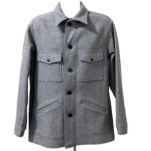 May include: A light gray long-sleeve jacket featuring a pointed collar, a central button-down placket with dark buttons, two chest pockets with buttoned flaps, and two slanted lower pockets. The garment has a structured fit and long sleeves.