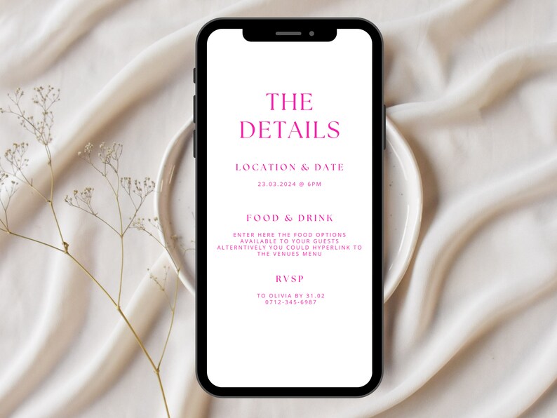 May include: A smartphone displays event details in pink text against a white background. The text reads "THE DETAILS," followed by location, date, and time. Additional text includes "FOOD & DRINK" and RSVP information. The phone rests on a white plate, with a beige fabric backdrop.