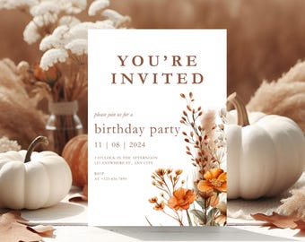 May include: A white card with brown text that reads "YOU'RE INVITED" and "birthday party". The date is 11 | 08 | 2024. The card is decorated with a watercolor illustration of dried flowers and pampas grass.