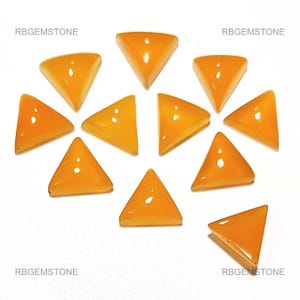 Op de afbeelding: Een verzameling van tien driehoekige, oranje edelstenen op een witte ondergrond. De edelstenen hebben een glanzende afwerking. De tekst "RBGEMSTONE" is zichtbaar in de hoeken. Deze edelstenen zijn geschikt voor het maken van sieraden.