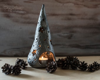 Handmade ceramic Christmas tree candle holder. Textured black pottery luminary with silvery metallic shine and holes in shape of stars.
