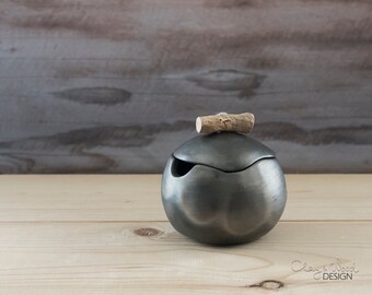 Handmade black ceramic cellar with lid for sugar or salt. Pot of black pottery without ceramic glaze. Nordic, minimalism.