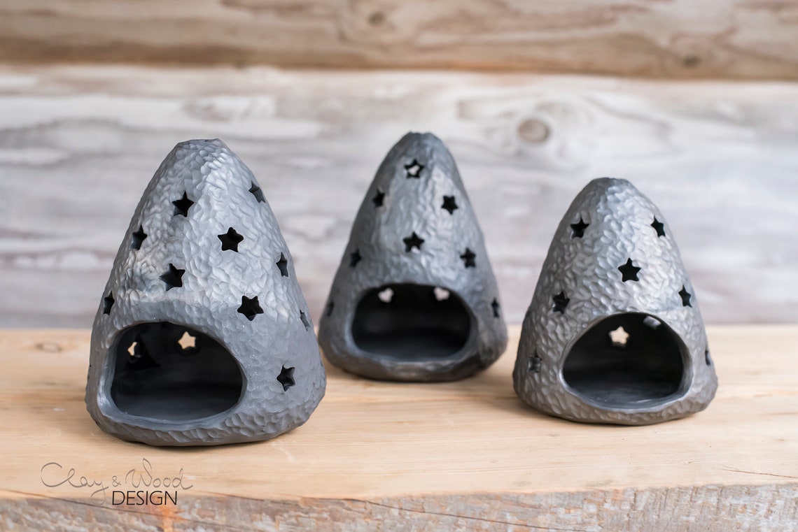 Handmade black ceramic candle holder with decorative holes in Etsy