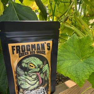 May include: A black stand-up pouch with a tan label featuring a green frog illustration and the text Frogman's Creek Bed Crack. The label includes a list of ingredients like sea salt, paprika, garlic, sugar, onion, and black pepper, with the brand name Appalachian Huntsman at the bottom.