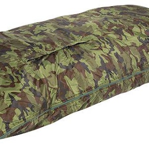 Könnte beinhalten: Ein rechteckiger Schlafsack mit einem Tarnmuster in Olivgrün, Braun und Schwarz. Der Schlafsack verfügt über einen durchgehenden seitlichen Reißverschluss, eine Schutzleiste über dem Reißverschluss und eine verstärkte Öse an der Basis.