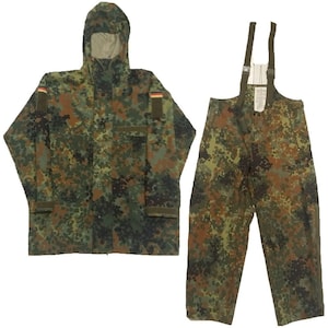 May include: A camouflage-patterned rain suit with a jacket and pants. The jacket has a hood and a zipper closure. The pants have suspenders. The suit is made of a waterproof material.