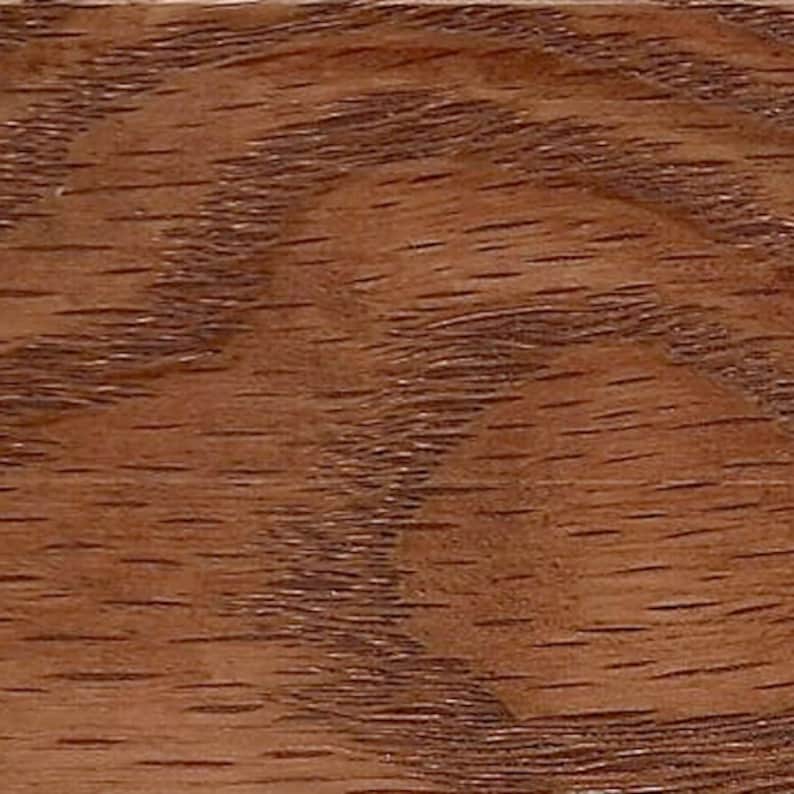 May include: Close-up of a wood grain pattern with a reddish-brown color.