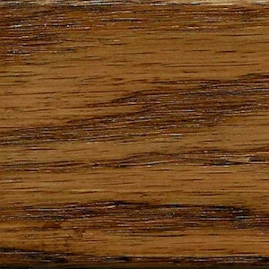 May include: Close-up of a wood grain pattern with a rich brown color and dark brown streaks.