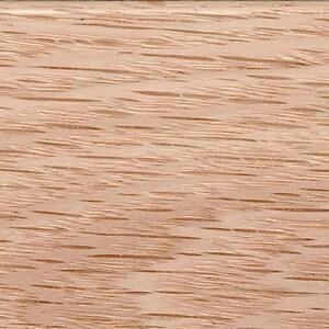 May include: Close-up of a light brown wood grain surface. The wood has a natural, unfinished look with a subtle reddish hue.