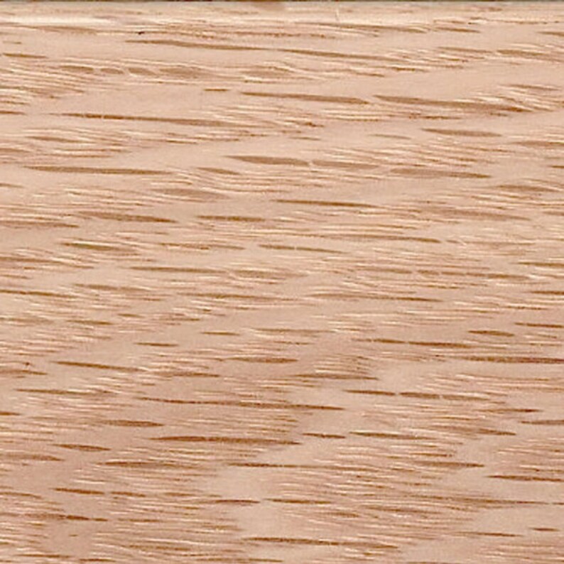 May include: Close-up of a light brown wood grain surface. The wood has a natural, unfinished look with a subtle reddish hue.