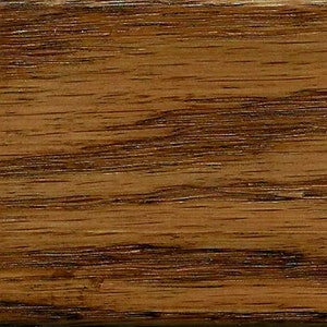 May include: Close-up of a wood grain pattern with a rich brown color and dark brown streaks.