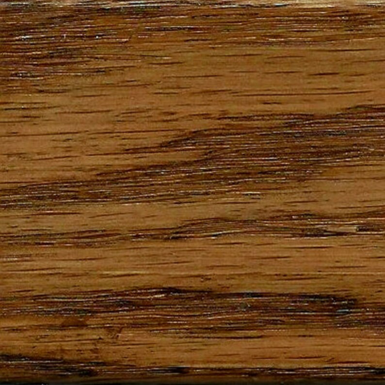 May include: Close-up of a wood grain pattern with a rich brown color and dark brown streaks.