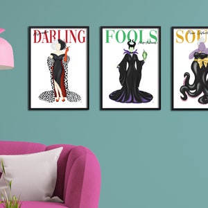 May include: Three framed prints featuring Disney villains. The first print features Cruella de Vil with the text "Darling". The second print features Maleficent with the text "Fools". The third print features Ursula with the text "Souls".