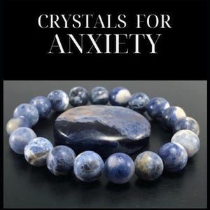 May include: A blue and white crystal bracelet and a blue and white crystal stone. The bracelet and stone are made of Sodalite, a crystal associated with calming anxiety. The text "CRYSTALS FOR ANXIETY" is displayed above the image.