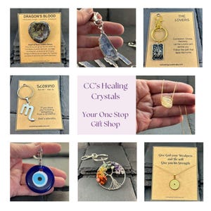 May include: A collage of various jewelry items including a Dragon's Blood stone, a blue crystal pendant, a The Lovers tarot card keychain, a Scorpio symbol keychain, a yellow crystal necklace, a blue evil eye charm, a tree of life keychain, and a cross necklace.