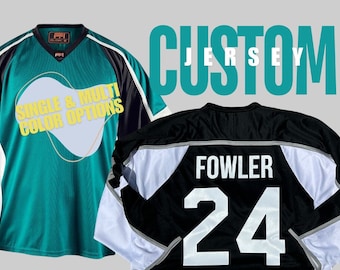 May include: Two custom jerseys, one green with black and white accents and the text "SINGLE & MULTI COLOR OPTIONS", and one black with white and silver accents, with the name "FOWLER" and the number "24" on the back.