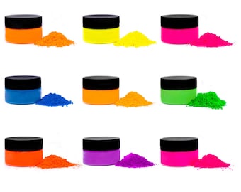 May include: Twelve small jars of neon pigment powder in various colors, including yellow, orange, pink, blue, green, purple, red, and white. Each jar has a black lid and is filled with a vibrant powder.