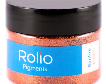 Puede incluir: Un tarro de purpurina naranja etiquetado como "Rolio Pigments" con el nombre del color "Bonfire" y el número "#LB400".