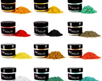 May include: Twelve small jars of Rolio pigments in various colors, including gold, silver, red, black, green, and blue. Each jar has a black lid and a white label with the Rolio logo and the word "Pigments".