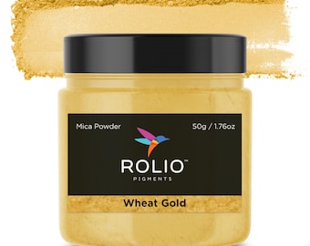 May include: A jar of Wheat Gold mica powder by Rolio Pigments. The jar is black with a white bird logo and the text "Mica Powder", "50g / 1.76oz", "Rolio Pigments", and "Wheat Gold".