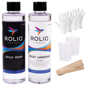 May include: Two clear plastic bottles with white labels, one labeled "Epoxy Resin" and the other "Epoxy Hardener". Both bottles are labeled with the brand name "Rolio Pigments" and contain 0.125 gallons of liquid. The image also shows two clear plastic measuring cups, three pairs of white disposable gloves, and three wooden mixing sticks.