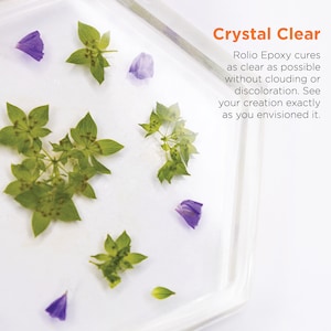 May include: A clear square resin tray with dried flowers and leaves inside. The text "Crystal Clear" is written in orange above the tray. The text below the tray reads "Rolio Epoxy cures as clear as possible without clouding or discoloration. See your creation exactly as you envisioned it."