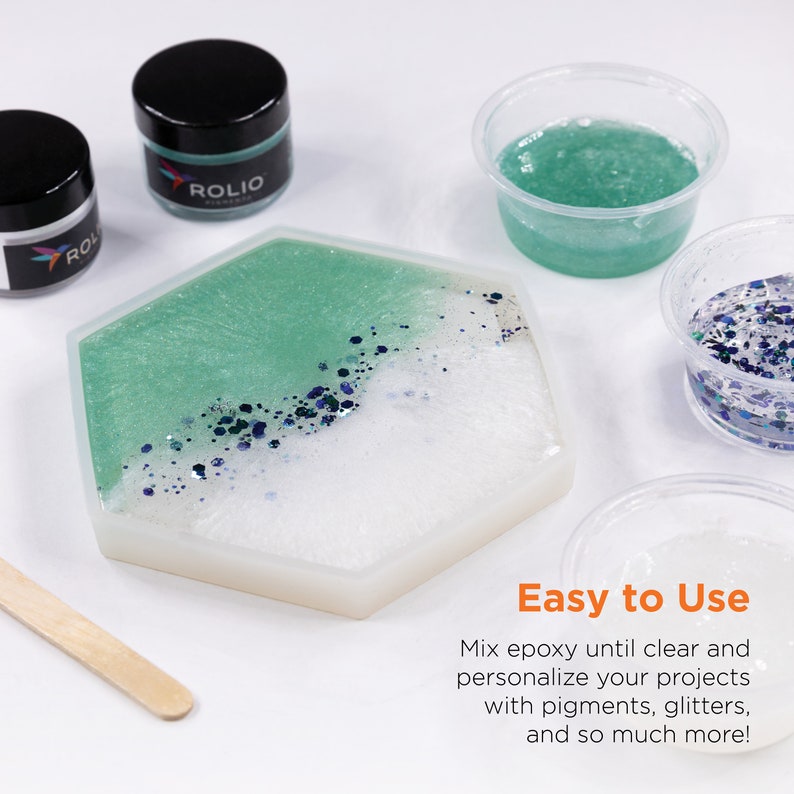May include: A hexagonal resin coaster with a white and green epoxy design and blue glitter. The coaster is on a white surface with two small jars of epoxy resin and a wooden stirring stick. The text "Easy to Use" is on the image.