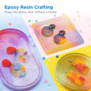 May include: Three colorful resin trays with different shapes and sizes, each containing a pair of earrings. The earrings are made of resin and have a rainbow-like pattern. The trays are on a yellow and white polka dot background.