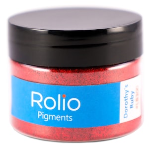 May include: A red glitter jar with a blue label that says "Rolio Pigments" and "Dorothy's Ruby".