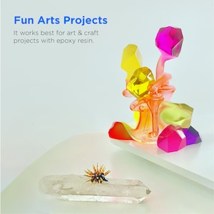 May include: A colorful abstract sculpture made of epoxy resin. The sculpture features a variety of shapes and colors, including yellow, orange, pink, and purple. The sculpture is sitting on a white surface. Fun Arts Projects. It works best for art & craft projects with epoxy resin.
