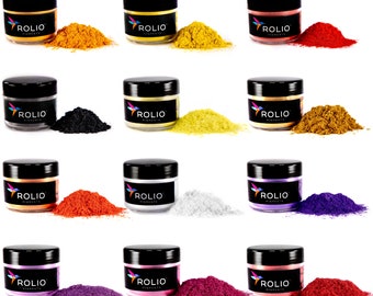 May include: Twelve small jars of ROLIO pigments in various colors, including gold, silver, red, orange, yellow, purple, pink, black, and white. Each jar has a black lid and a label with the ROLIO logo and the word "pigments".