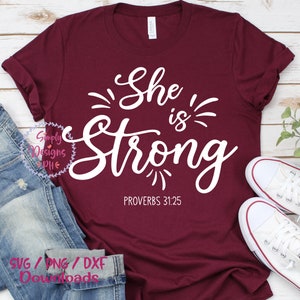 May include: A maroon t-shirt with white text that reads "She is Strong" and "Proverbs 31:25".