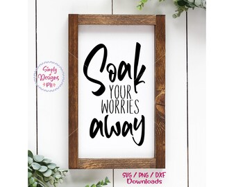 Puede incluir: Un letrero enmarcado en madera con el texto "Soak your worries away" en letra cursiva negra.