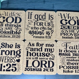 May include: Six cork coasters with inspirational bible verses printed in black. The verses include "With God all things are possible", "If God is for us who can be against us?", "Where God guides He provides", "She is strong", "As for me and my house we will serve the Lord", and "Faith it does not make things easier it makes them possible".