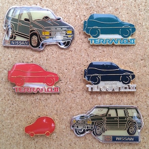 Vintage Nissan Terrano pins: Red and blue Nissan Terrano II, Terrano V6 & Patrol GR enamel pins