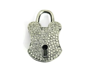 May include: A silver padlock charm with a keyhole, completely covered in small, clear diamonds.